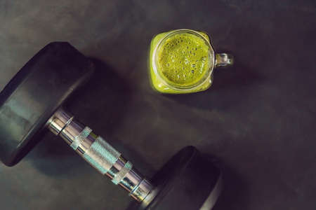 green smoothies and dumbbells in the gym.の写真素材