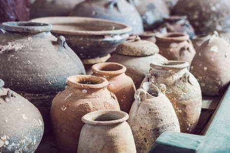 Ancient Vietnamese traditional pots overgrown with seashells.の写真素材