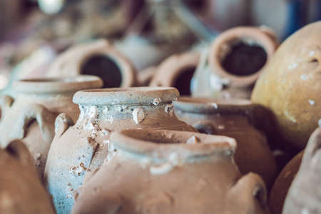 Ancient Vietnamese traditional pots overgrown with seashells.