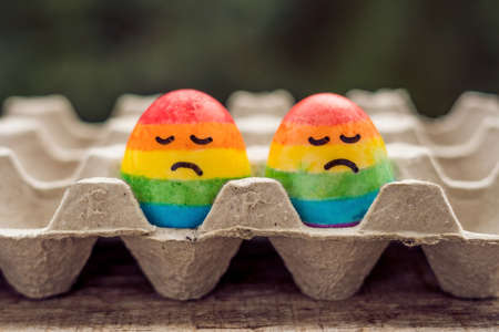 Two eggs are colored in the colors of the rainbow as a flag of gays and lesbians as well as Easter eggs. Homosexual concept.の写真素材