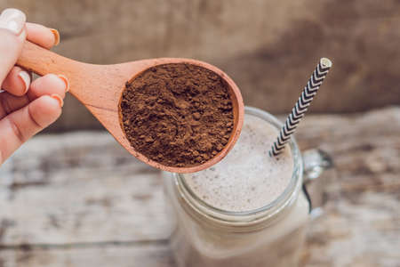 Drink from carob and kerob powder in a wooden spoon.の写真素材