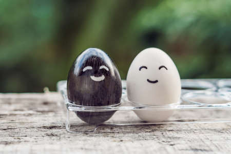 interracial marriage concept. Black and white egg as a pair of different races.の写真素材