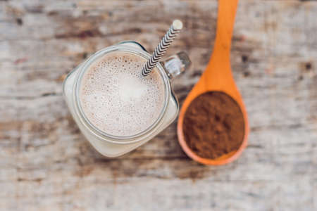 Drink from carob and kerob powder in a wooden spoon.の写真素材