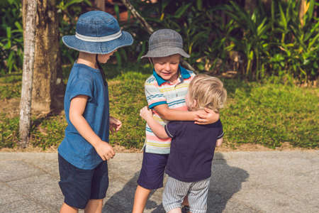 Three children of different age have fun outdoor