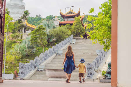 Happy tourists mom and son in Pagoda. Travel to Asia concept. Traveling with a baby concept.の写真素材