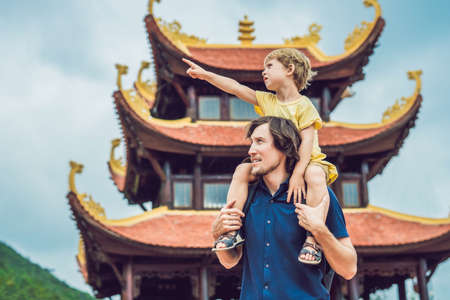 Happy tourists dad and son in Pagoda. Travel to Asia concept. Traveling with a baby concept.の写真素材