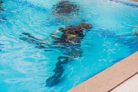 Diving instructor and students. Instructor teaches students to dive.の写真素材
