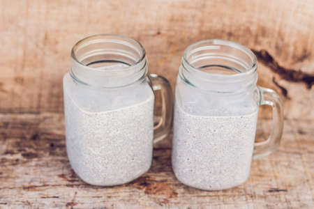 Chia seed pudding with almond milk on a wooden backgroundの写真素材