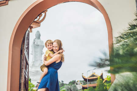 Happy tourists mom and son in Pagoda. Travel to Asia concept. Traveling with a baby concept.の写真素材