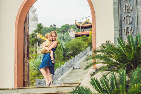 Happy tourists mom and son in Pagoda. Travel to Asia concept. Traveling with a baby concept.の写真素材