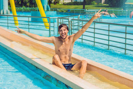 Young man having fun at water parkの写真素材