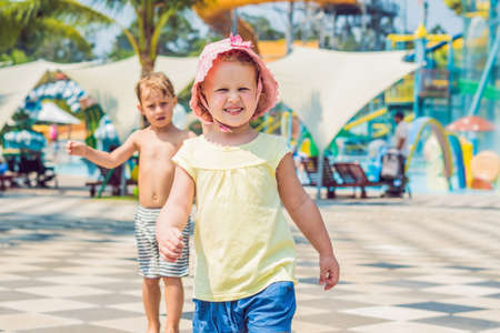 Boy and girl have fun in the water park.の写真素材