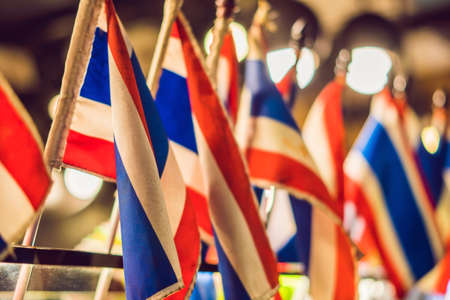 ten small Thai flags indoors on the background of bokeh lights.の写真素材