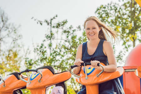 Beautiful, young woman having fun at an amusement park.の写真素材