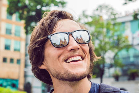 A man looks at Notre dame de Saigon Cathedral, build in 1883 in Ho Chi Minh city, Vietnam. Reflection in glasses.の写真素材