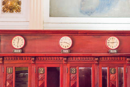 wall clocks showing time in different capitals of the world.