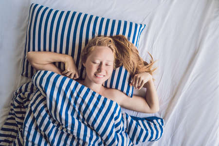 Young beautiful woman woke up in bed close-up.