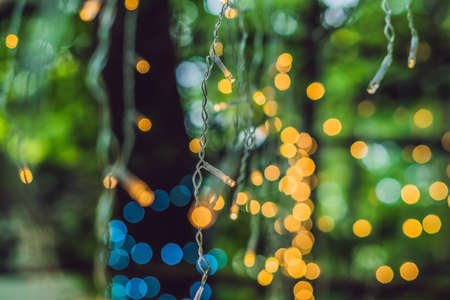 LED lights garland, colorful light bulbs on a bokeh background.の写真素材