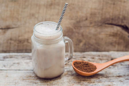 Drink from carob and kerob powder in a wooden spoon.の写真素材