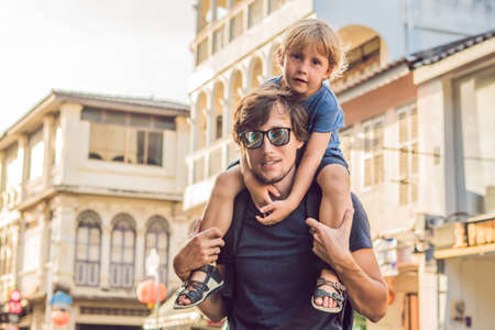 Dad and son are tourists on the Street in the Portugese style Romani in Phuket Town. Also called Chinatown or the old town. Traveling with children conceptの写真素材