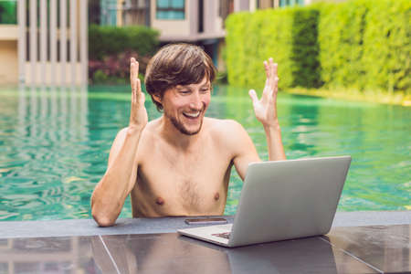 Young freelancer working on vacation next to the swimming pool.の写真素材
