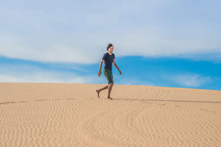 A man is walking in the desert Vietnam, Mui Ne.の写真素材