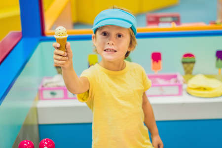 Children play as ice cream seller in the ice cream shopの写真素材