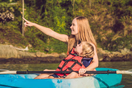 Mother and son kayaking at tropical ocean. Travel and activaties with children concept.の写真素材