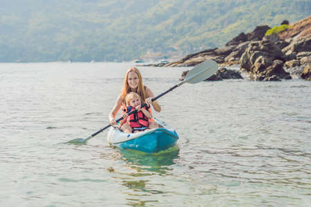 Mother and son kayaking at tropical ocean. Travel and activaties with children concept.の写真素材