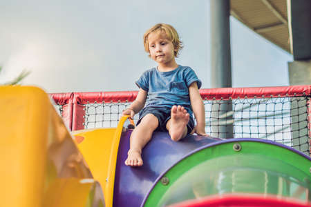 Adorable little toddler boy having fun on playground.の写真素材