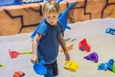Boy playing with sand in preschool. The development of fine motor concept. Creativity Game concept.の写真素材
