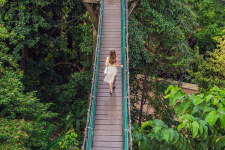 Young woman at the Suspension bridge in Kuala Lumpur, Malaysiaの写真素材