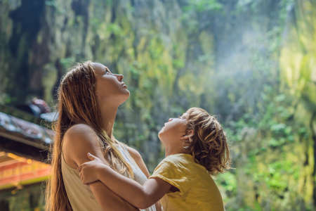 Mom and son in the background of Batu Caves, near Kuala Lumpur, Malaysia.の写真素材