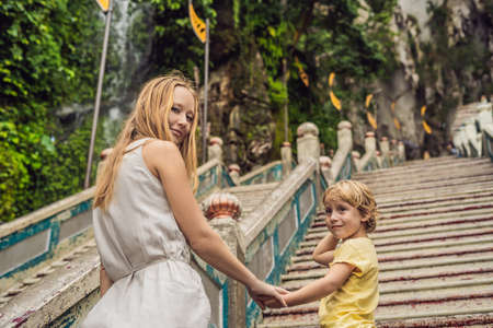 Mom and son in the background of Batu Caves, near Kuala Lumpur, Malaysia.の写真素材