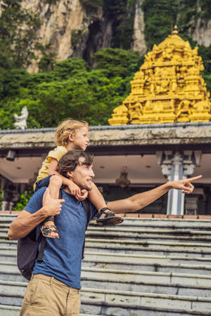Father and son in the background of Batu Caves, near Kuala Lumpur, Malaysia.の写真素材