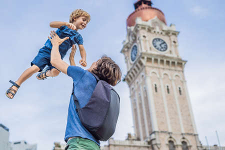 Dad and son on background of Sultan Abdul Samad Building in Kuala Lumpur, Malaysia.の写真素材