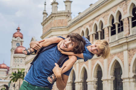 Dad and son on background of Sultan Abdul Samad Building in Kuala Lumpur, Malaysia.の写真素材