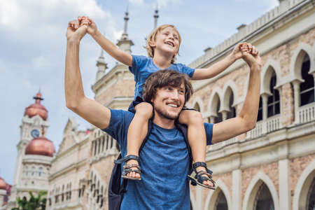 Dad and son on background of Sultan Abdul Samad Building in Kuala Lumpur, Malaysia.の写真素材