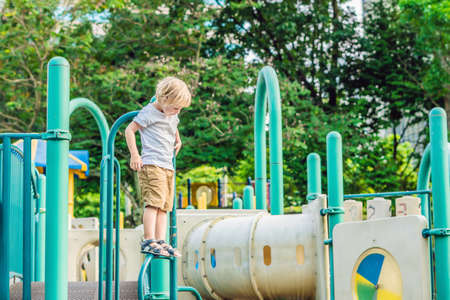 Funny cute happy boy playing on the playground.の写真素材