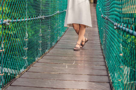 Young woman at the Suspension bridge in Kuala Lumpur, Malaysia.の写真素材