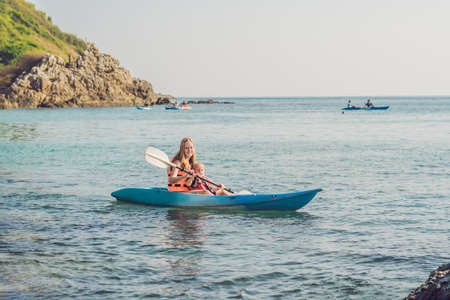 Mother and son kayaking at tropical ocean. Travel and activaties with children concept.の写真素材