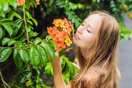 Young woman enjoying a beautiful blooming garden.の写真素材