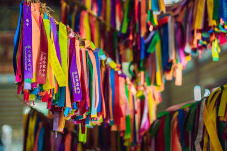 Ribbons tied on the tree of desires in a Buddhist temple.の写真素材