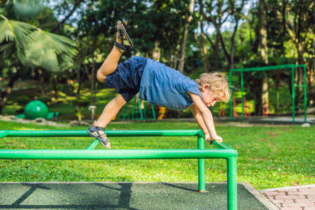 Portrait of child doing yoga in the park.