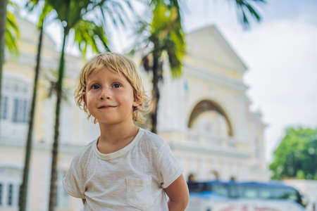 Boy on background of Old Town Hall in George Town in Penang, Malaysia. The foundation stone was laid in 1879. Traveling with children concept.の写真素材