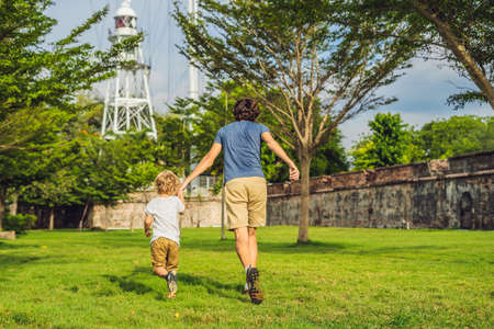 Dad and son on background of Fort Cornwallis in Georgetown, Penang, is a star fort built by the British East India Company in the late 18th century, it is the largest standing fort in Malaysia. Traveling with children concept.の写真素材