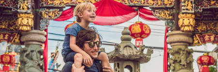 Dad and son are tourists on the Street in the Portugese style Romani in Phuket Town. Also called Chinatown or the old town. Traveling with children concept BANNER, long formatの写真素材