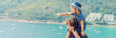 Father and son in the background of Promthep cape and Yanui beach. Phuket, Thailand. Traveling with children concept. BANNER, long formatの写真素材