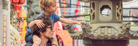 Dad and son are tourists on the Street in the Portugese style Romani in Phuket Town. Also called Chinatown or the old town. Traveling with children concept BANNER, long formatの写真素材