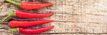 a Chilli pepper on old wooden surface. BANNER, long formatの写真素材